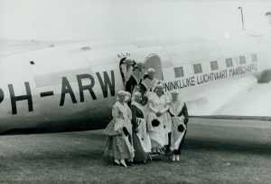 Op 25 en 26 juni 1938 werd ter gelegenheid van de opening van het vliegveld Leeuwarden een groot vliegfeest gehouden. Hier poseert een Friese folkloristische dans- en zanggroep voor een DC-3 van de KLM. Beeld: Johannes Doedes de Jong/Tresaor, CC BY-NC 4.0